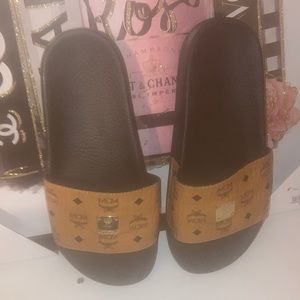 Cognac leather strap with gold logo plaque and rubber sole MCM sandal.